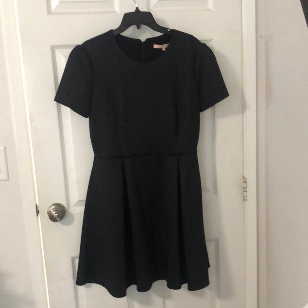 Black Aline dress with pockets on each side.